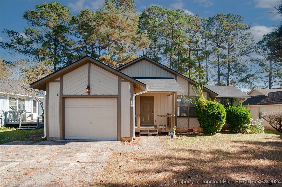 a view of a house with a yard and garage