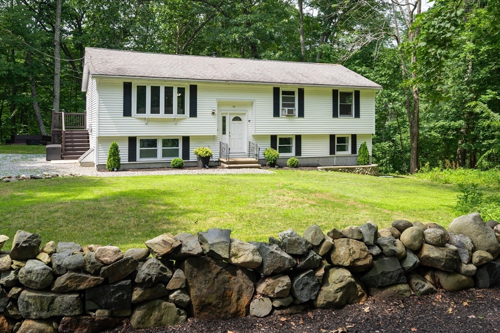 a front view of house with yard and outdoor seating