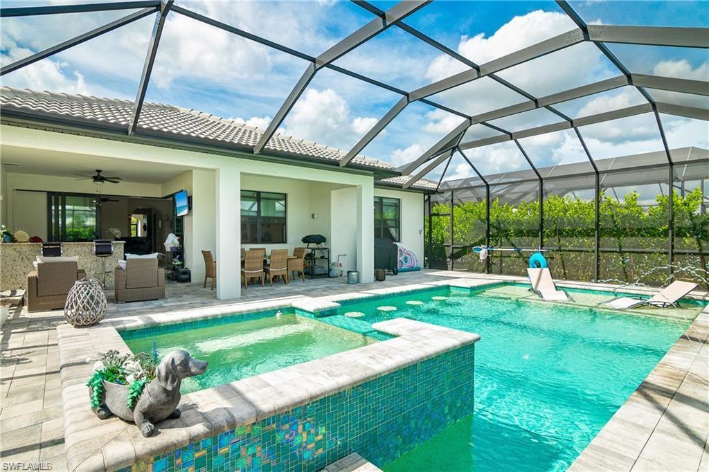 a view of a house with a yard patio and furniture