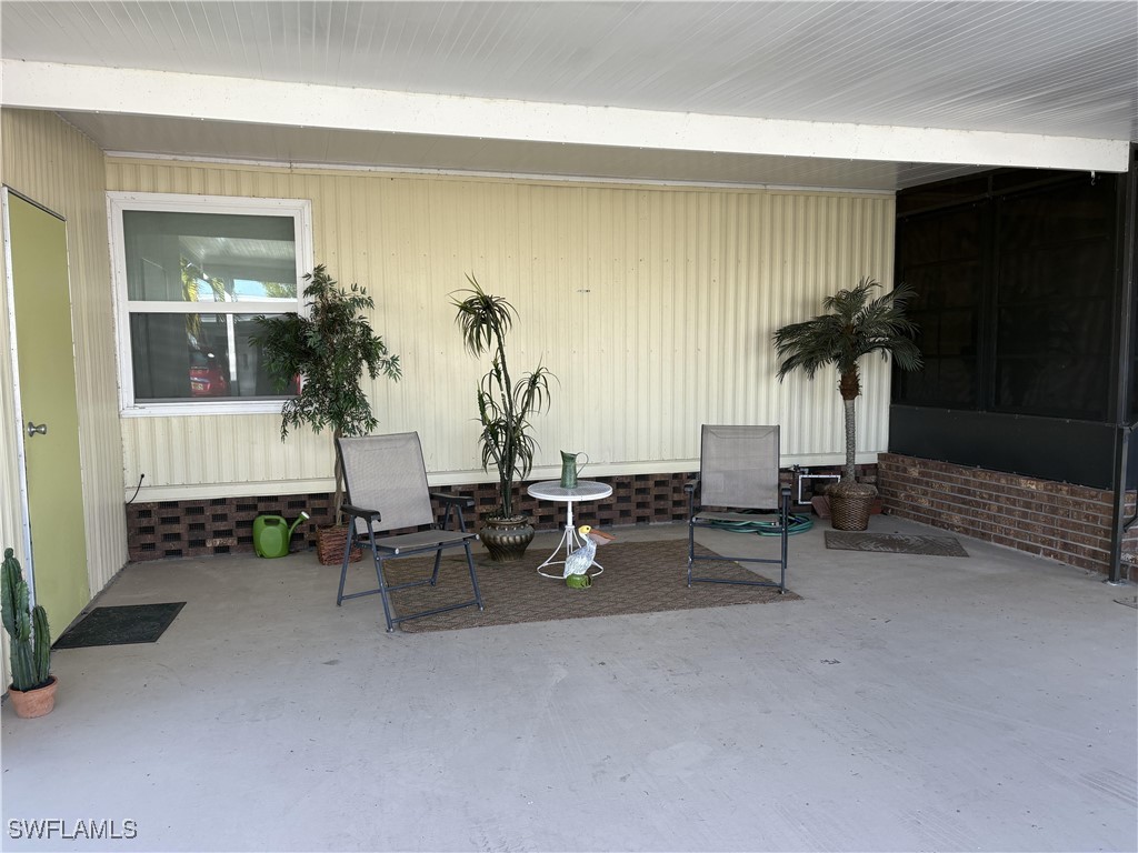 a living room with furniture and potted plants