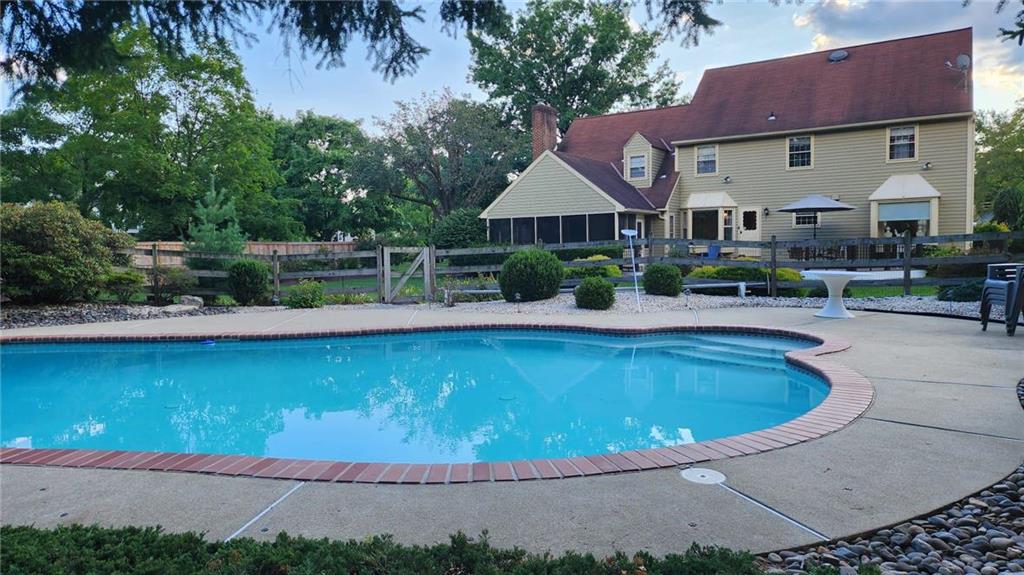 a view of house with outdoor space and swimming pool