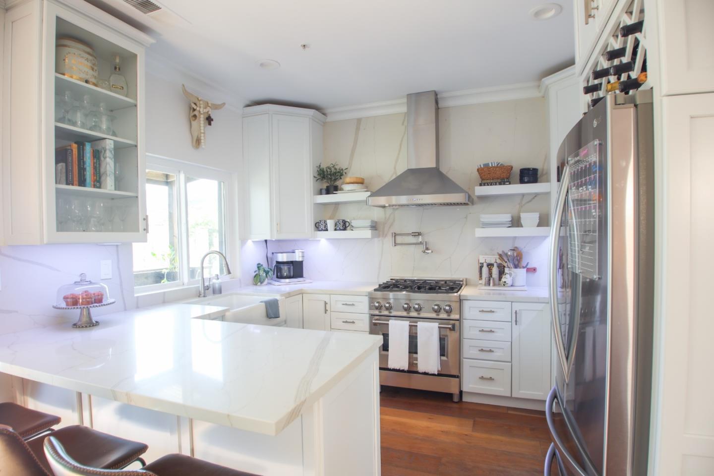 a kitchen with stainless steel appliances granite countertop a sink stove and refrigerator