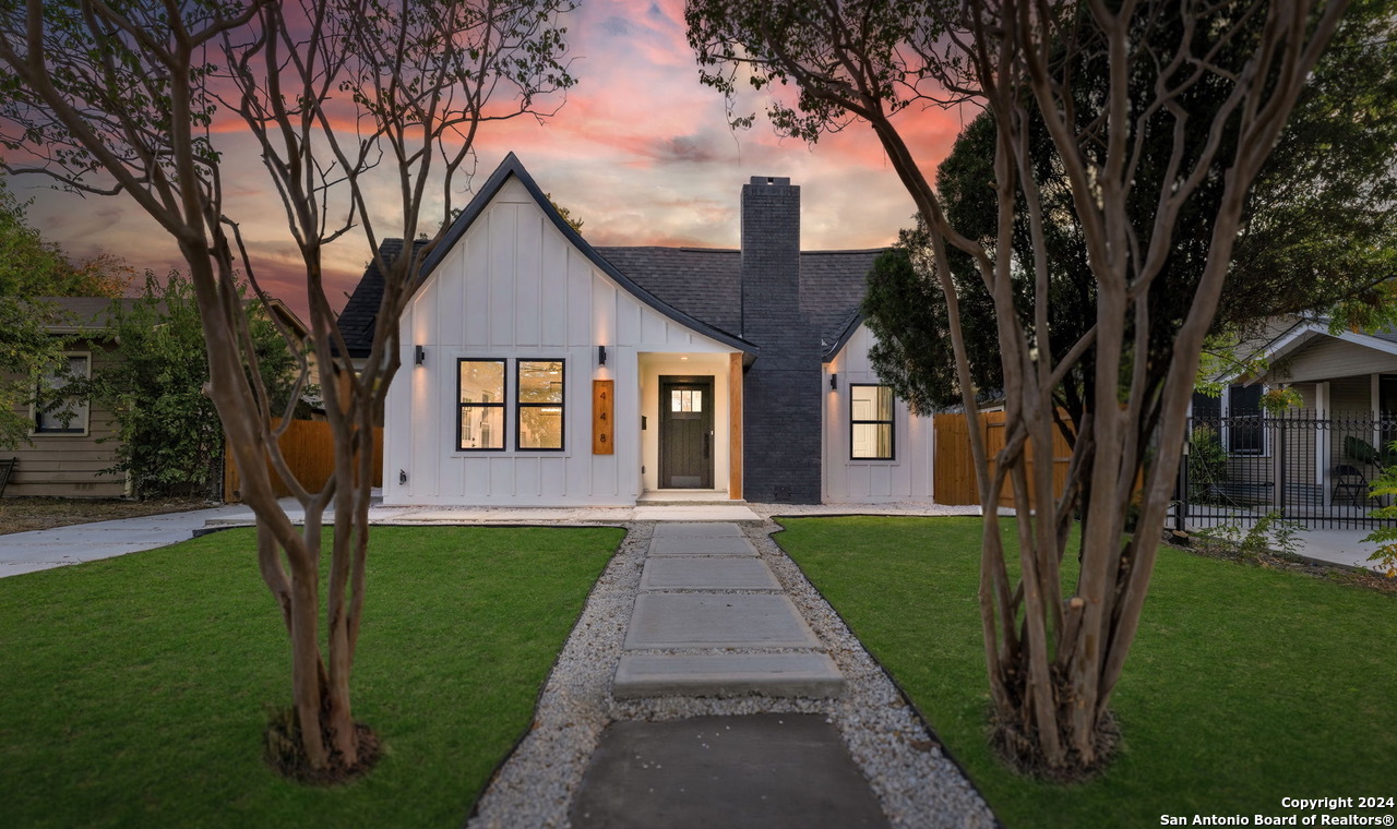 a front view of a house with garden