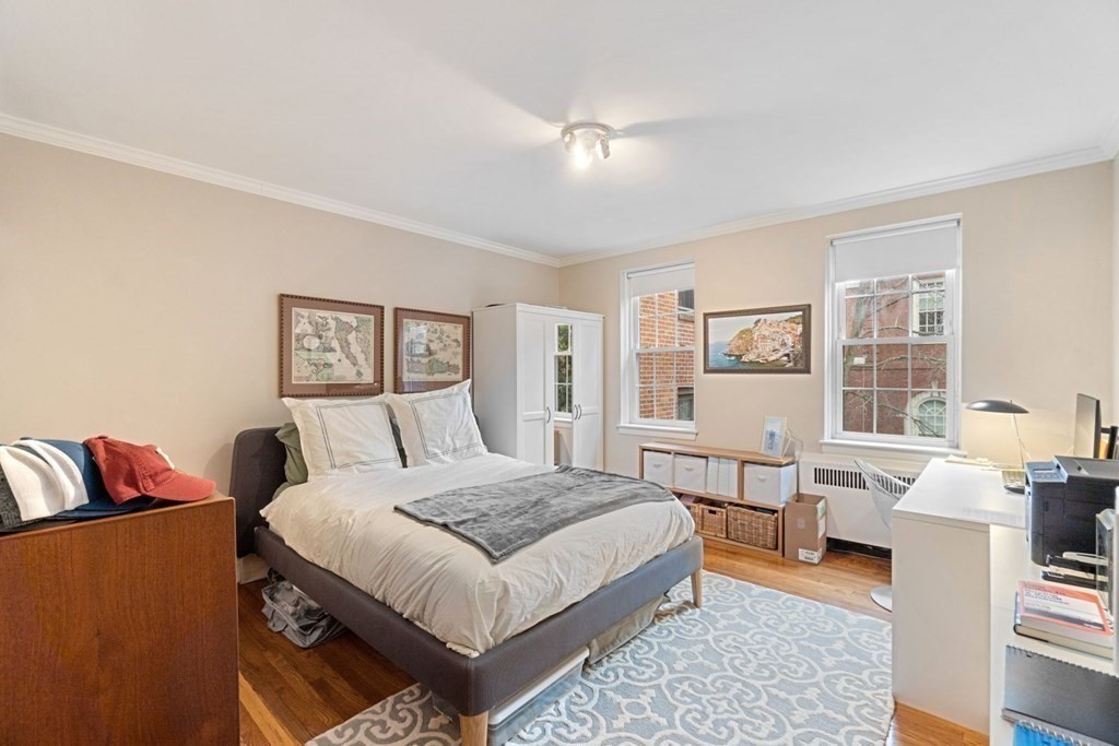 a bedroom with a bed couch and a window