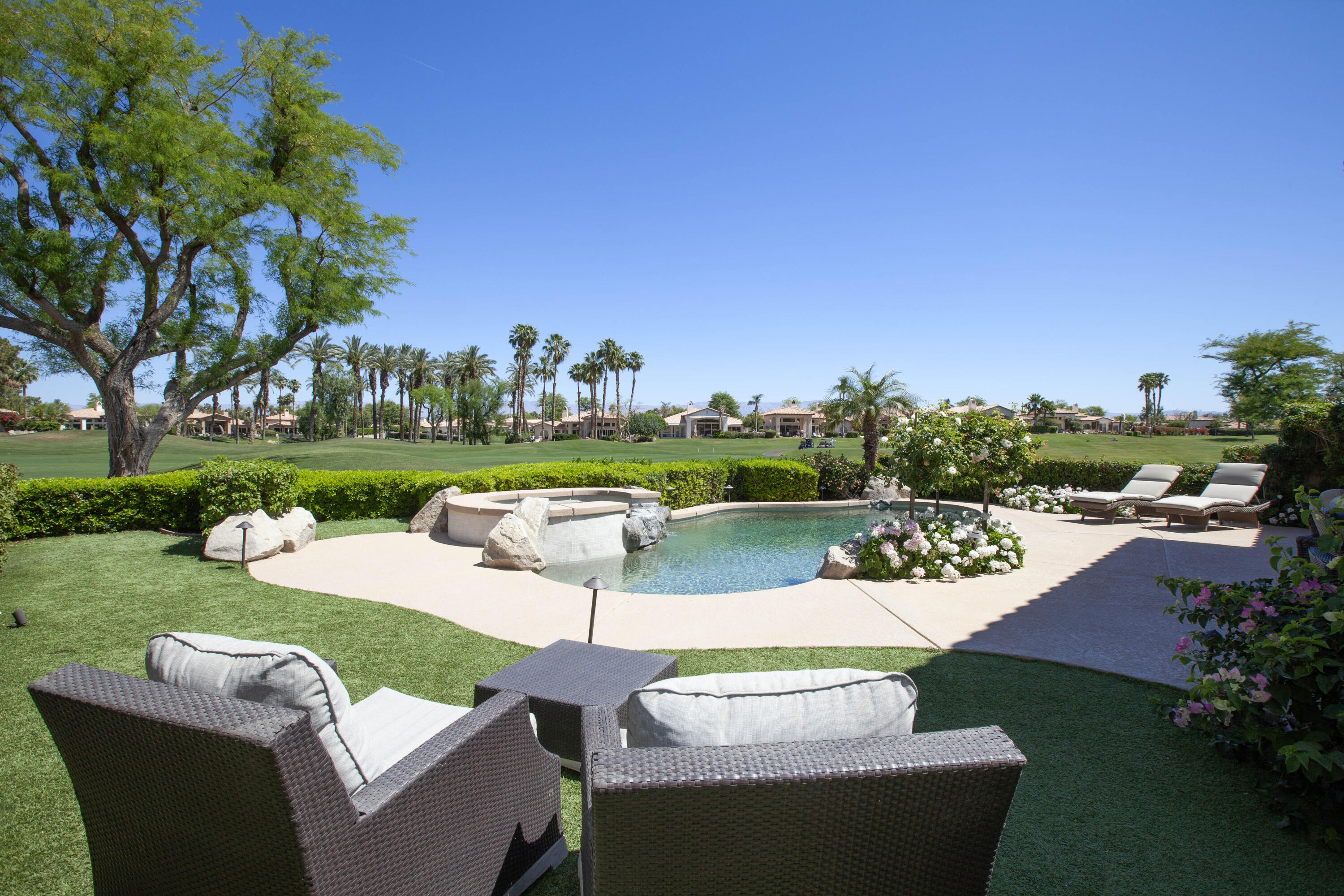 a view of a house with a yard and a patio