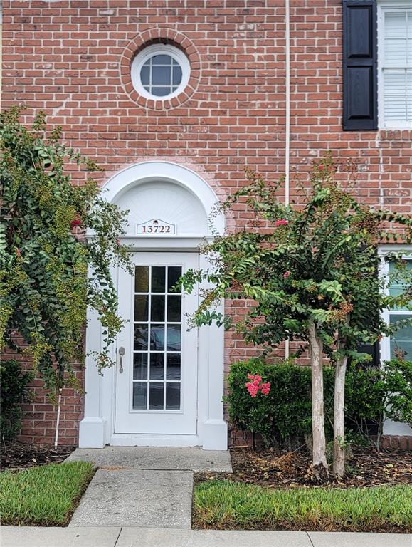 a front view of a house with plants