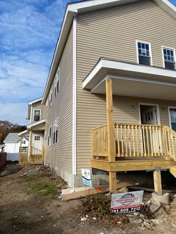 a view of house with wooden deck