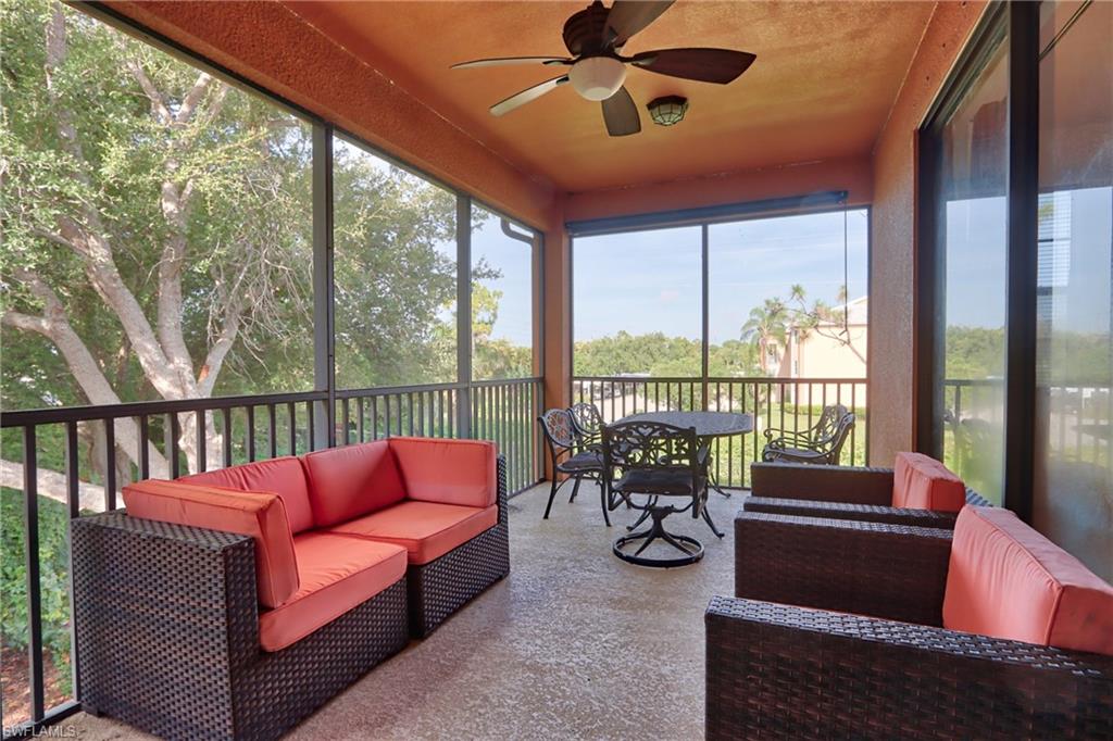 a balcony with furniture and a potted plant