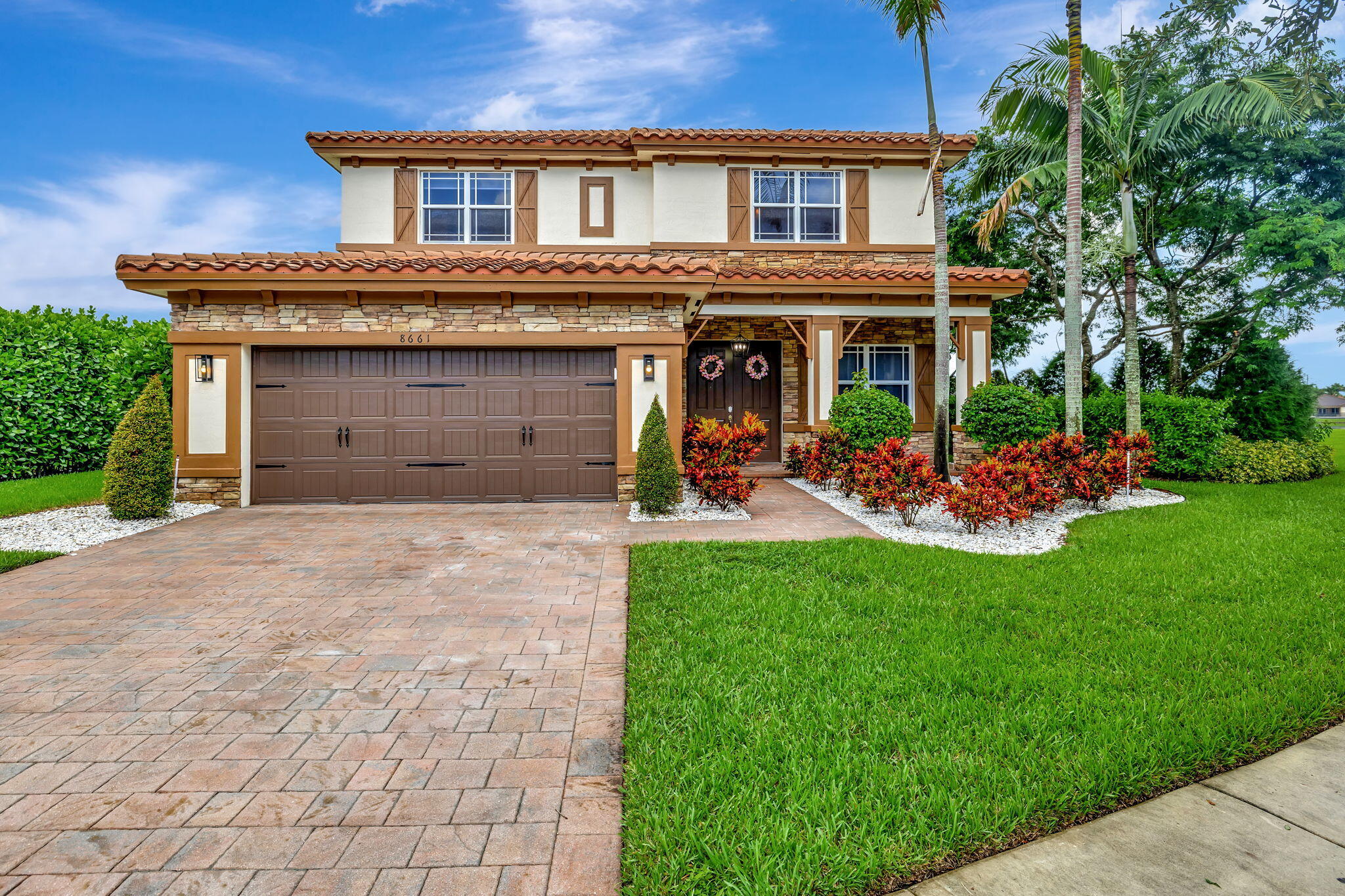 a front view of a house with a yard and garage