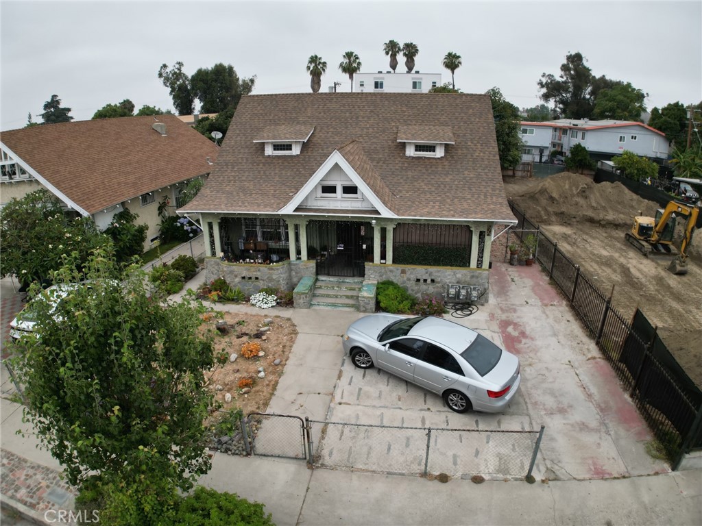 an aerial view of a house with garden space and street view