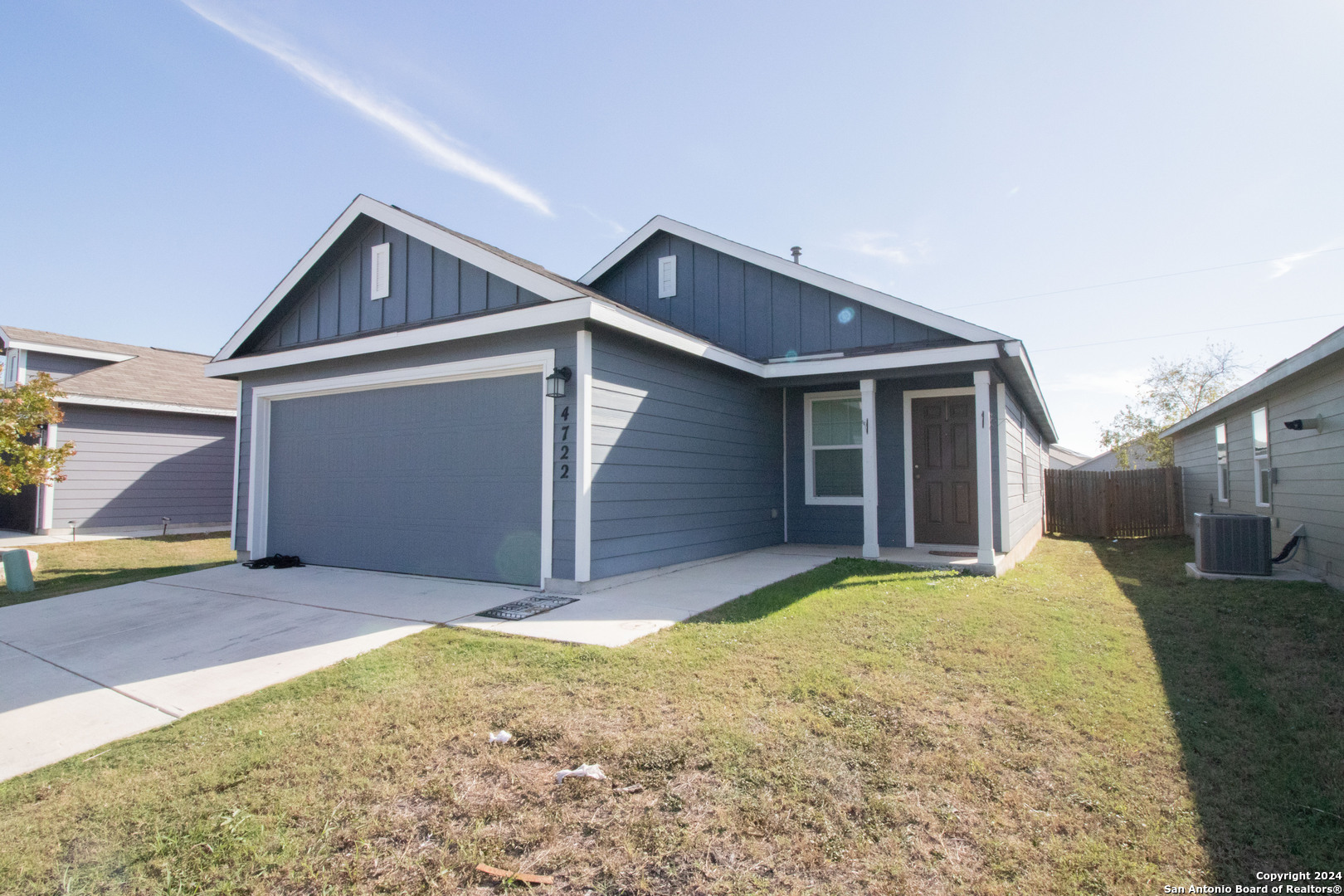 a view of a house with a yard and garage