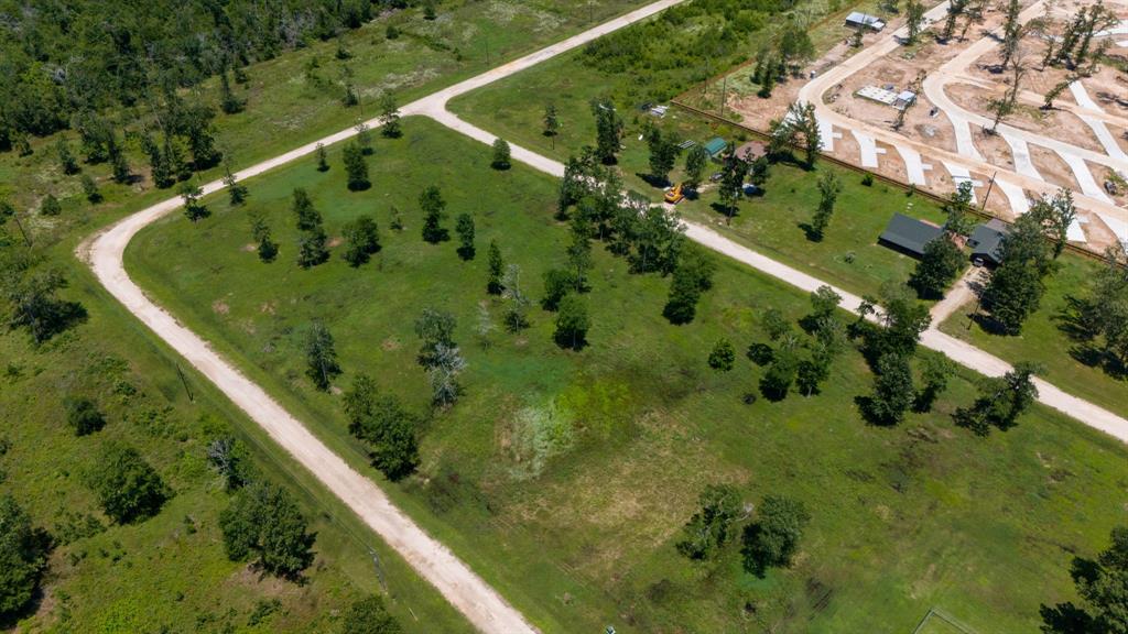 an aerial view of a residential houses with outdoor space and street view