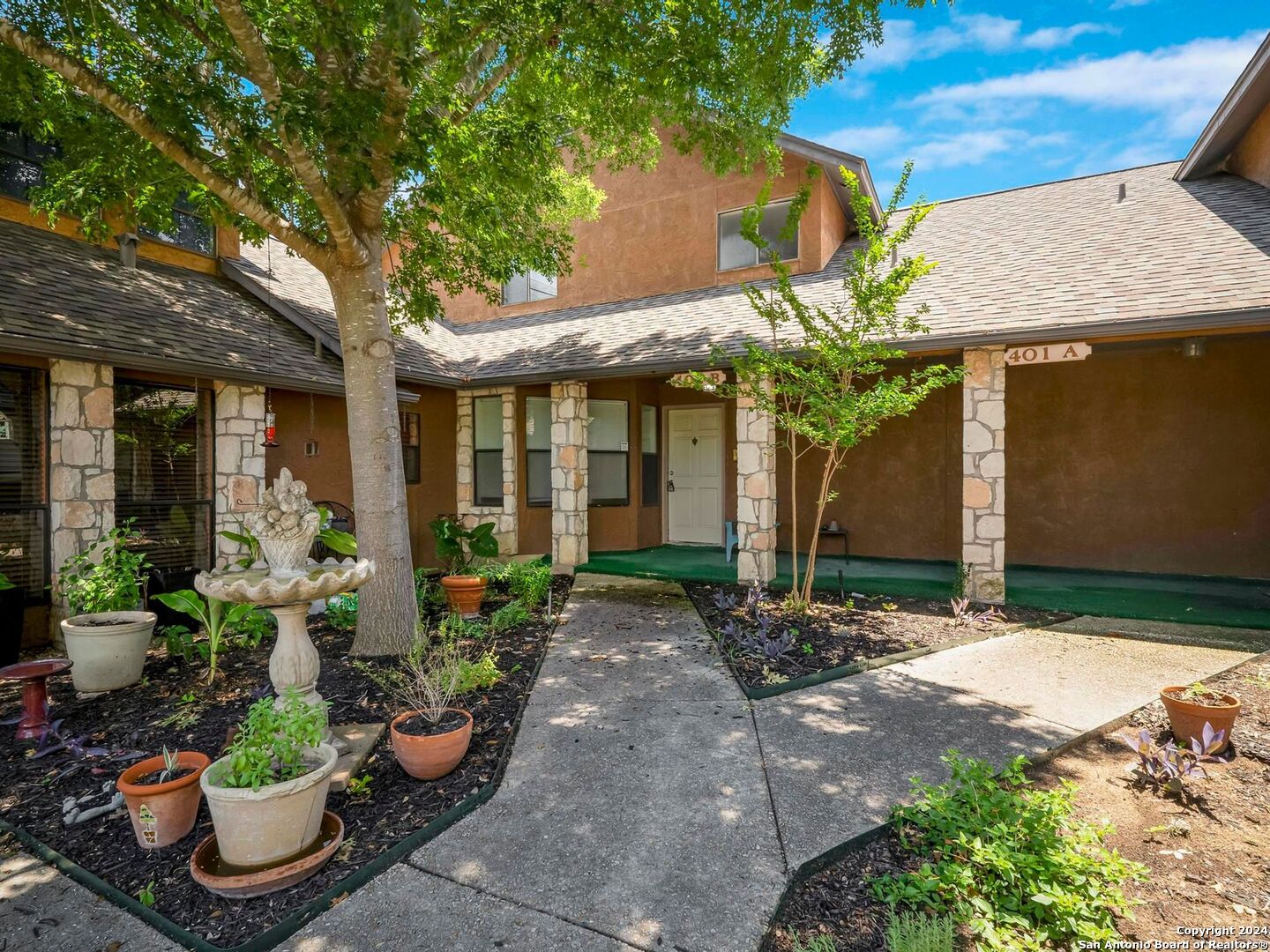 a front view of a house with plants