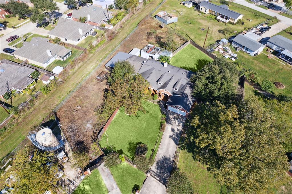 an aerial view of a house with a yard and a fountain