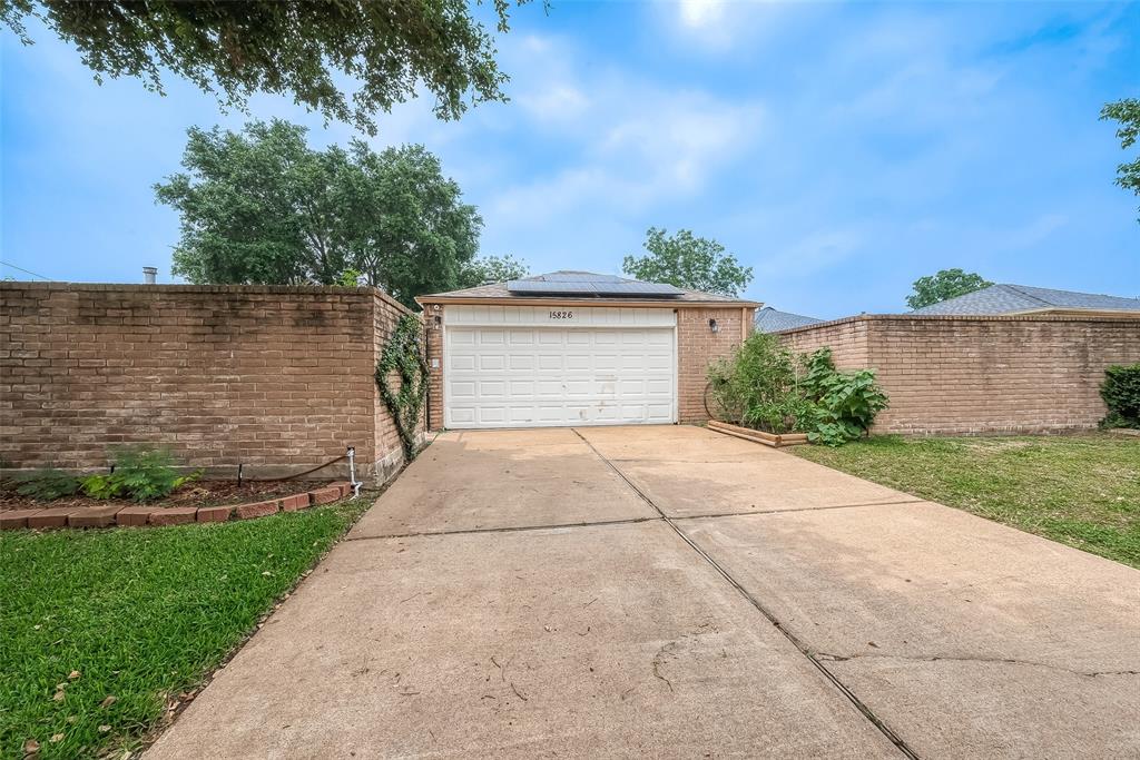 a front view of a house with a yard and a garage