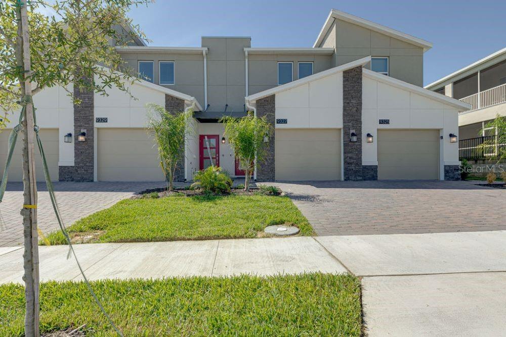 a front view of a house with a yard and garage