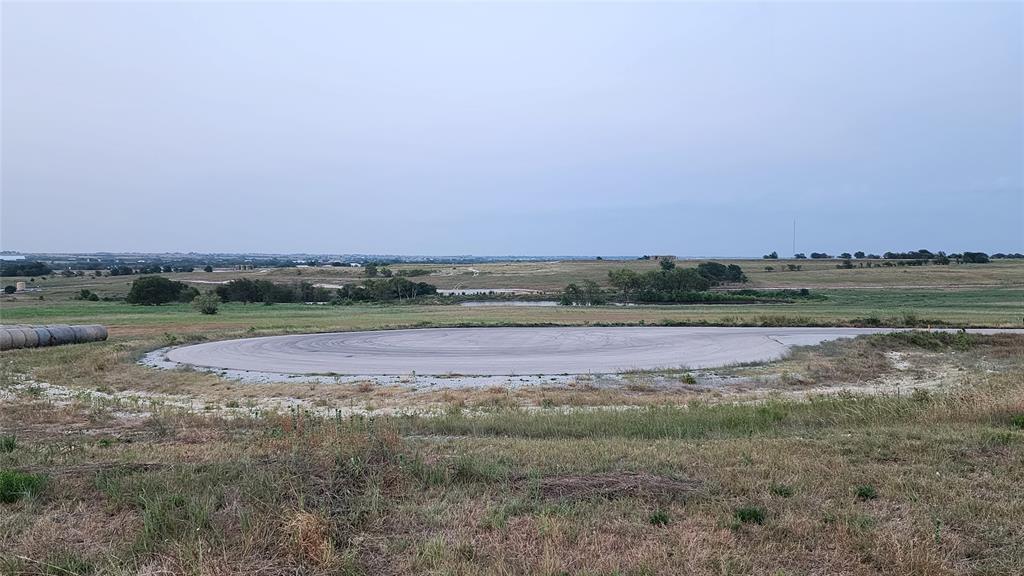 a view of a field with ocean view