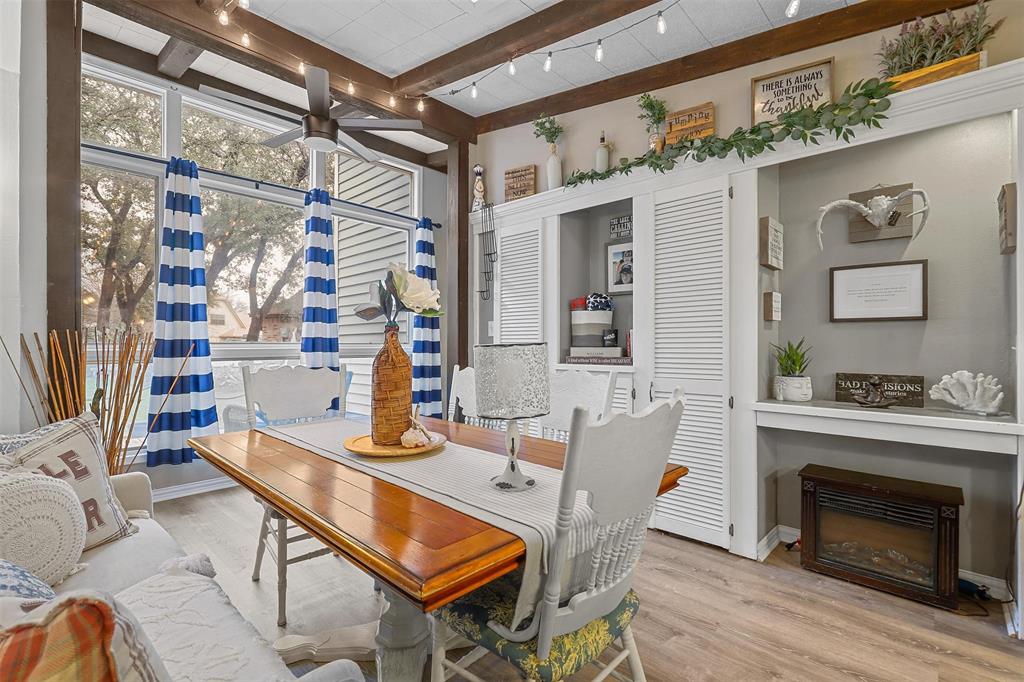 a dining room with wooden floor table and chairs