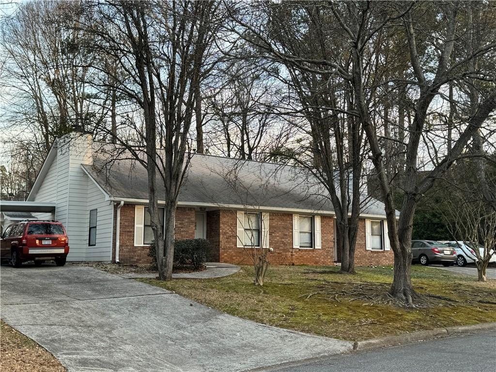 a house view with a car parked in front of house