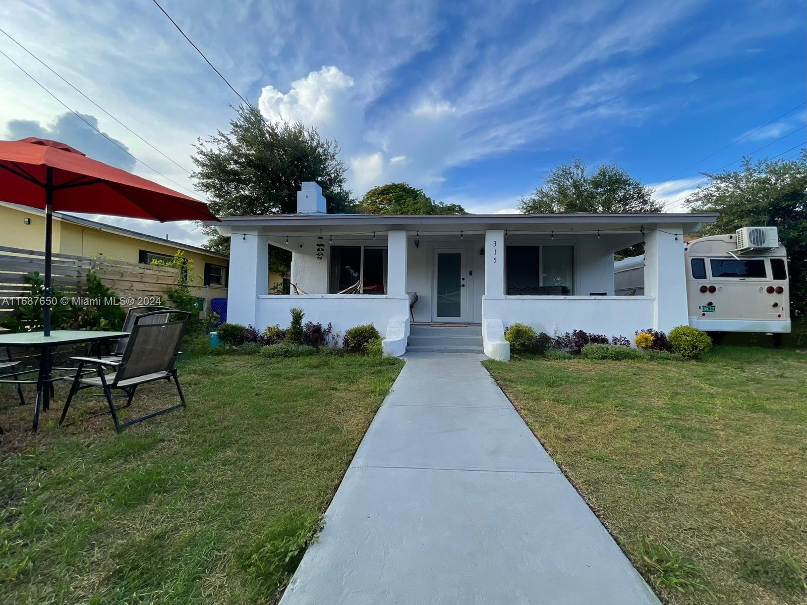 a front view of house with yard and green space