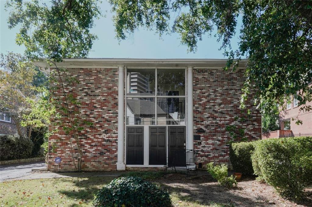 front view of a house with a tree