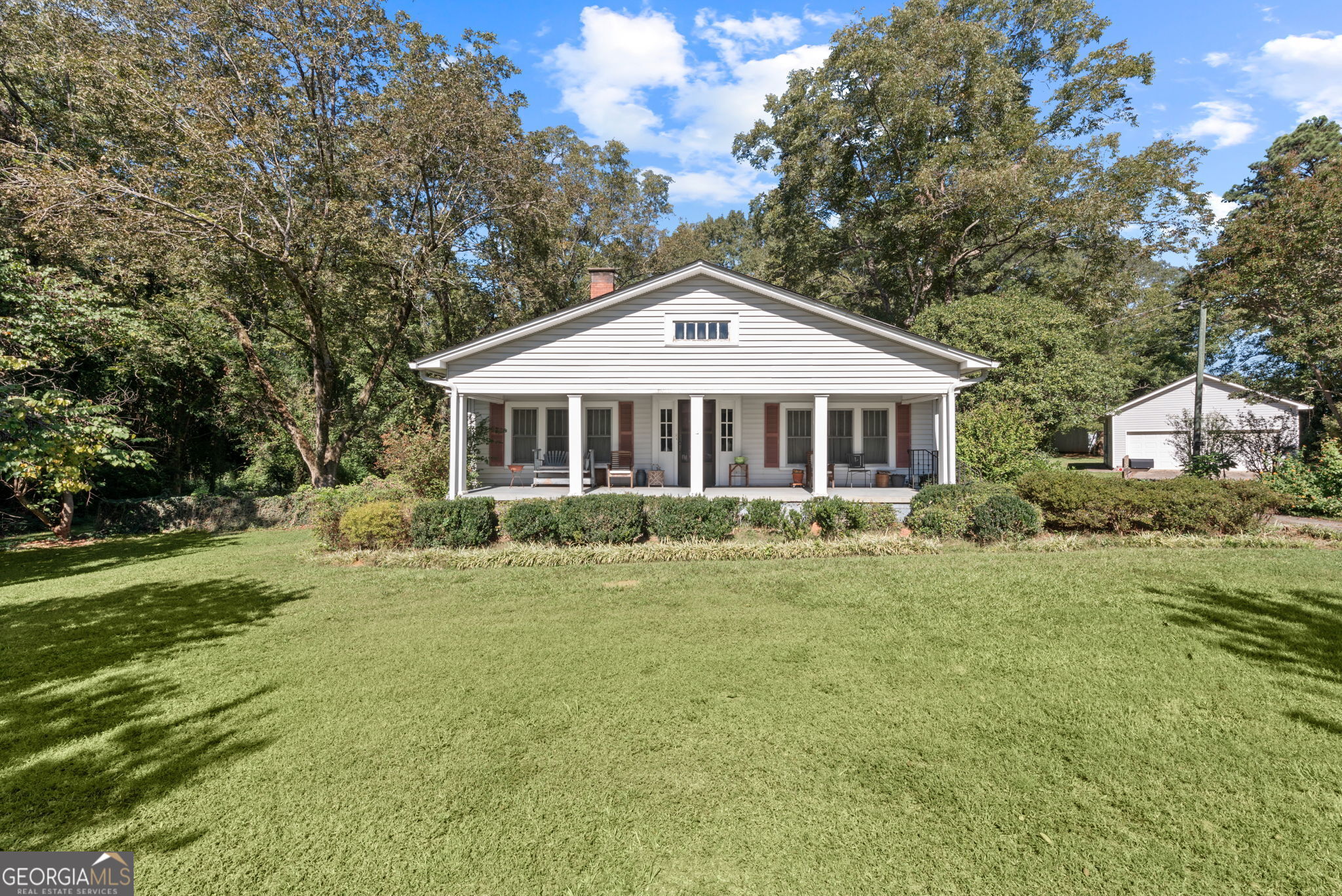 a front view of a house with a garden