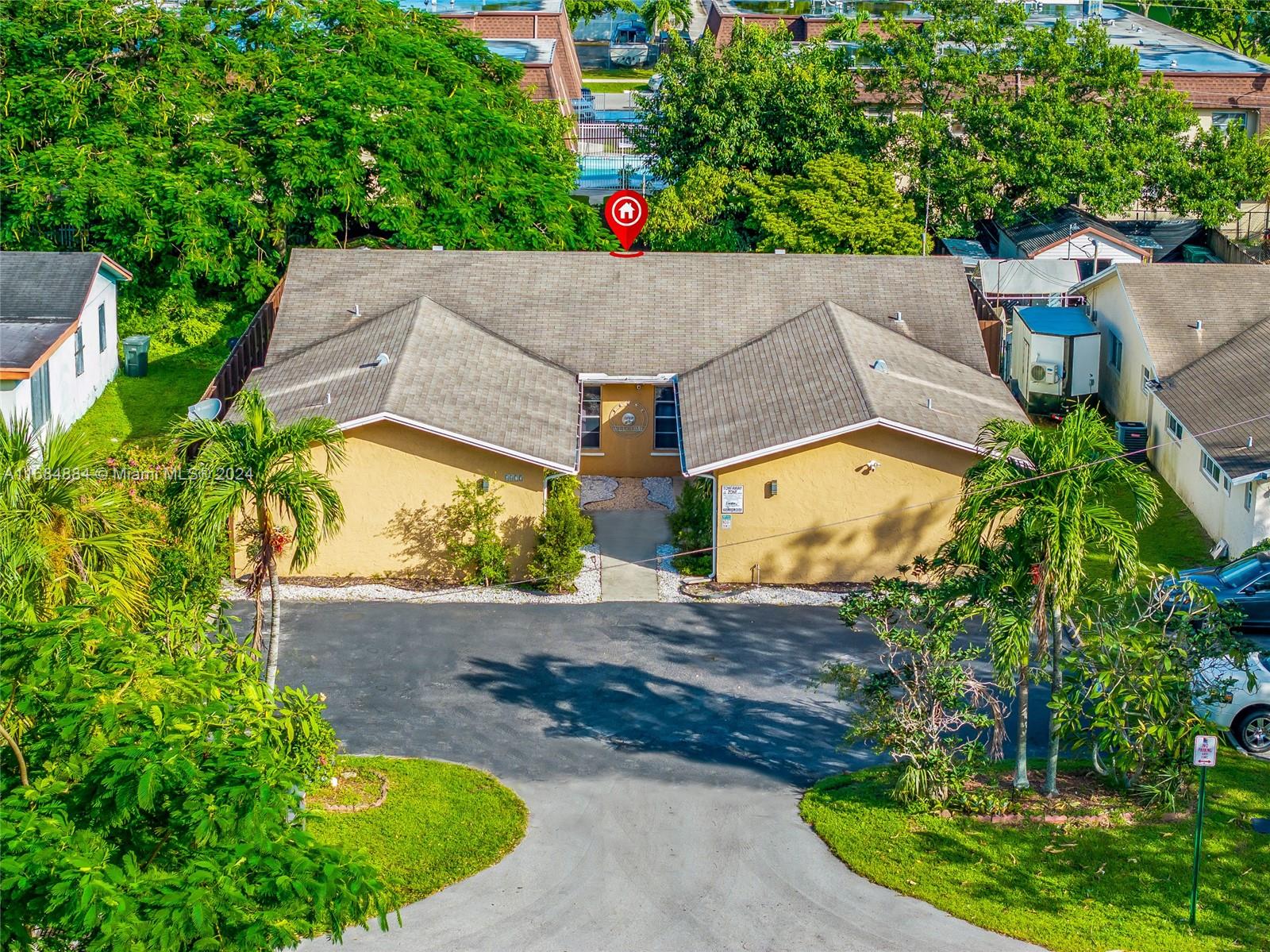 an aerial view of a house with a yard basket ball court and outdoor seating