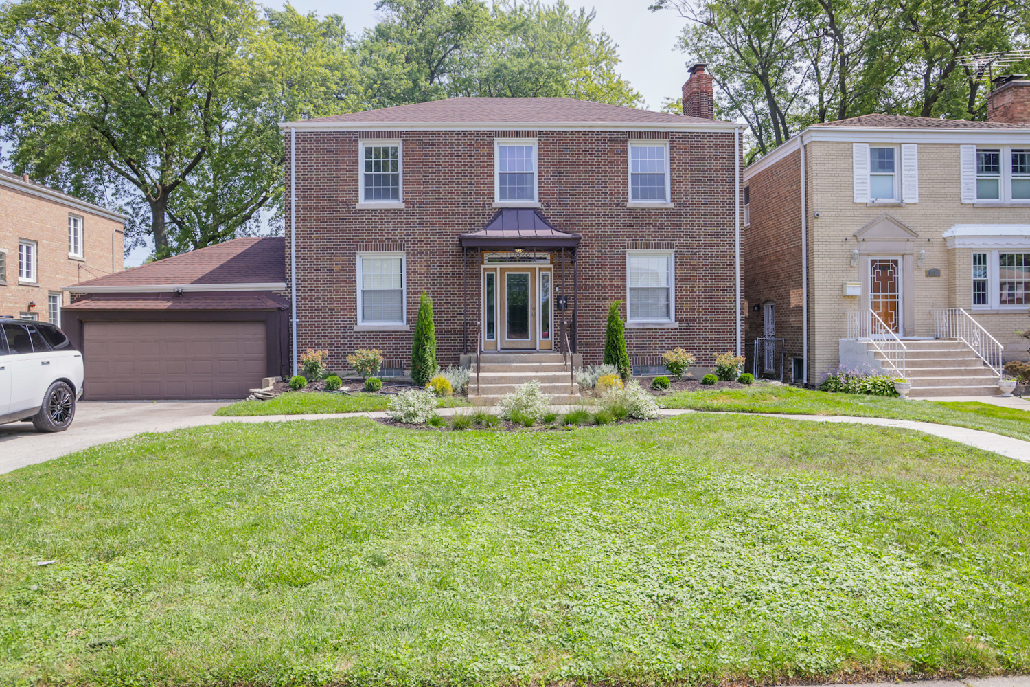 a front view of a house with garden