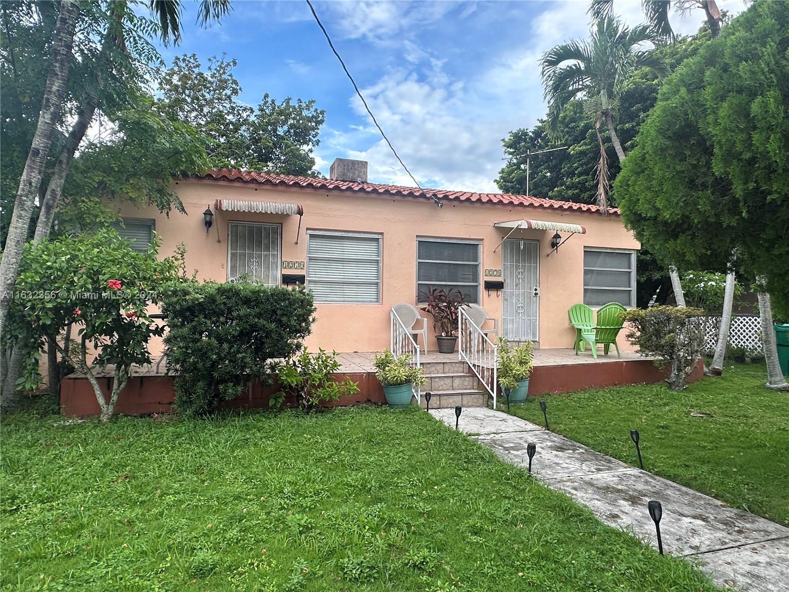 a front view of house with yard and green space