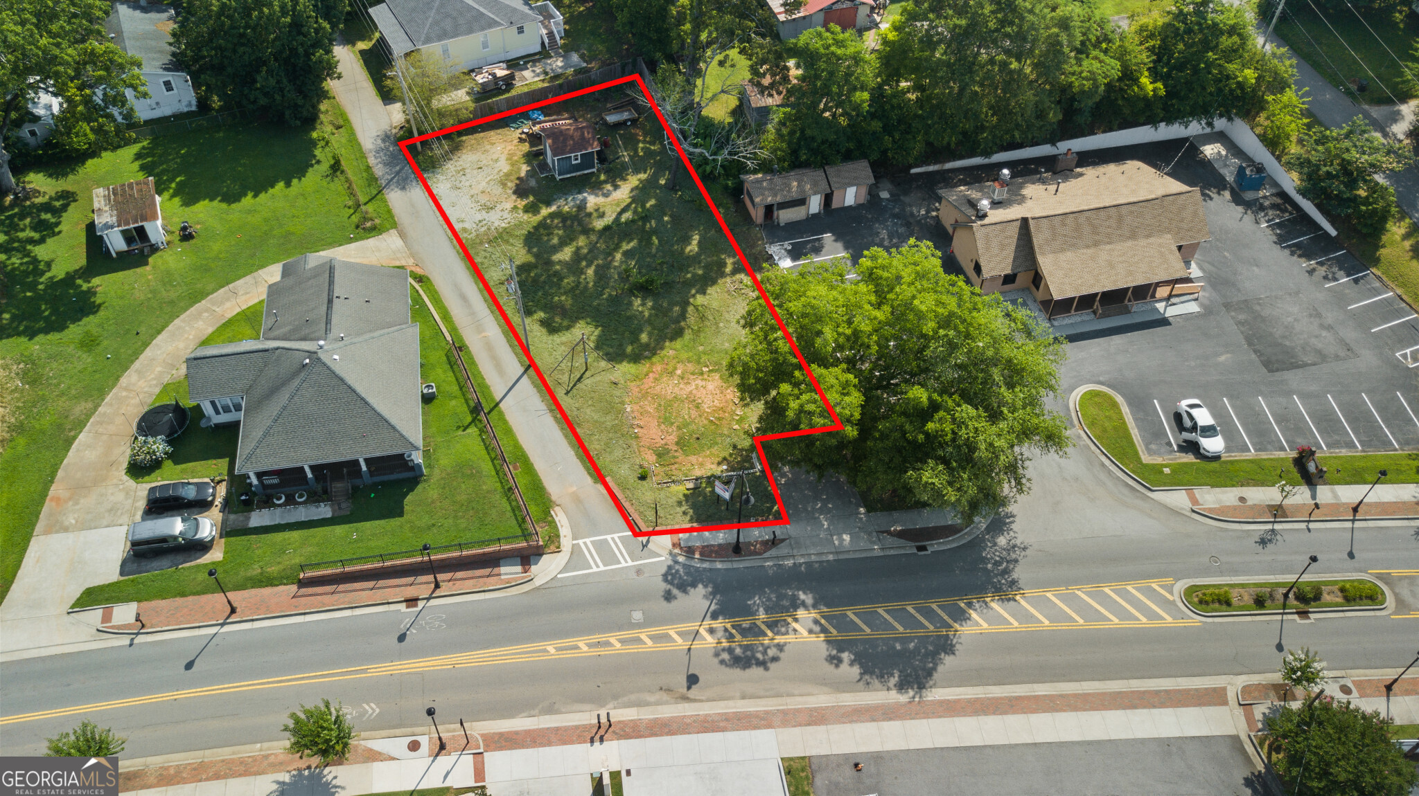 an aerial view of a house with a yard and potted plants