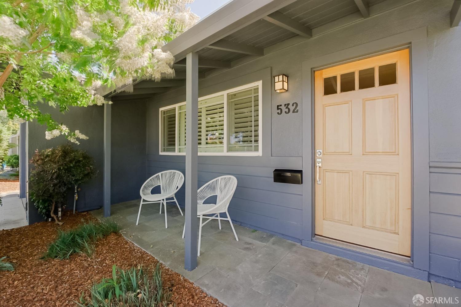 a view of backyard with outdoor seating and a potted plant