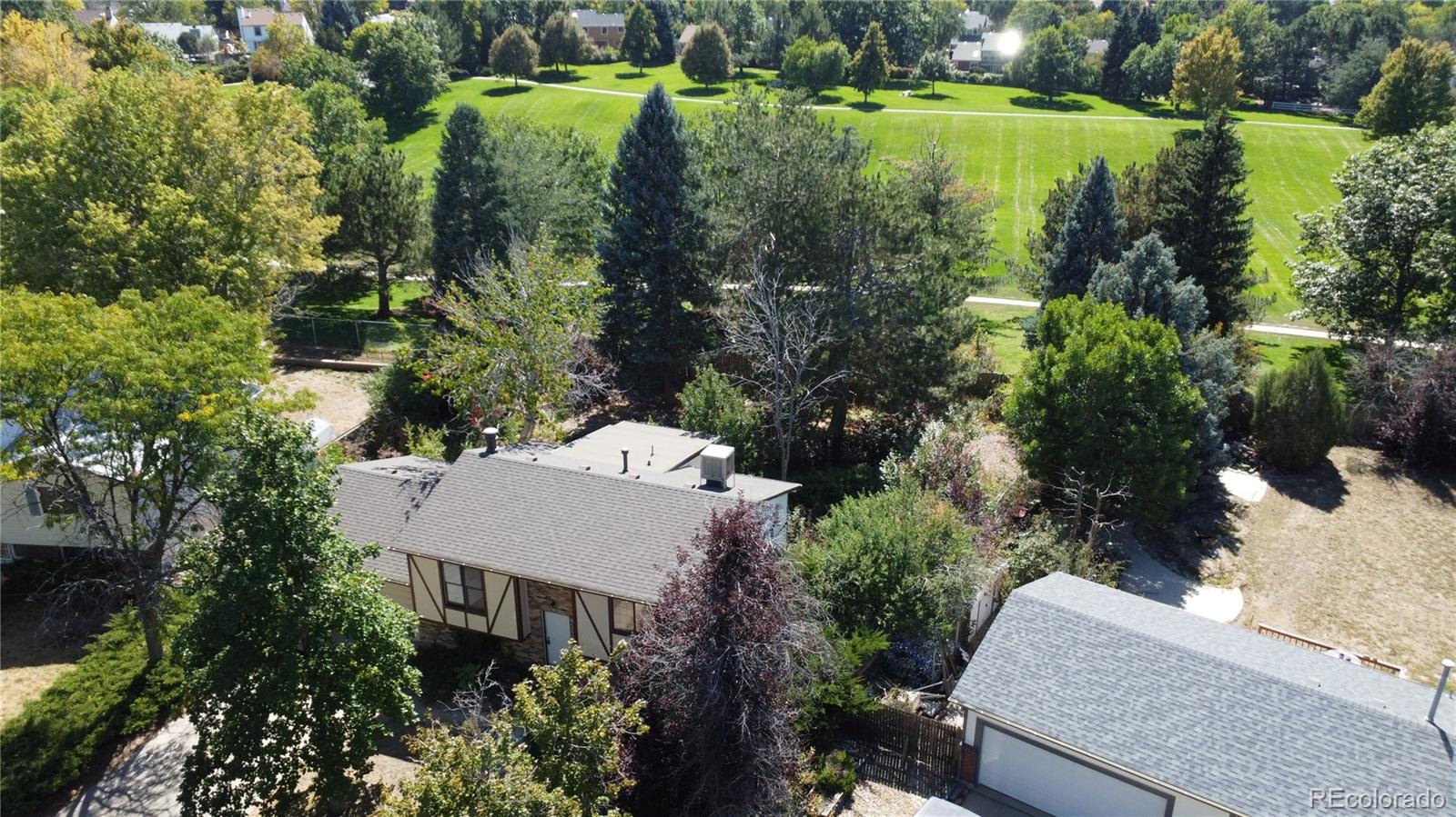 an aerial view of a house with a yard and lake view