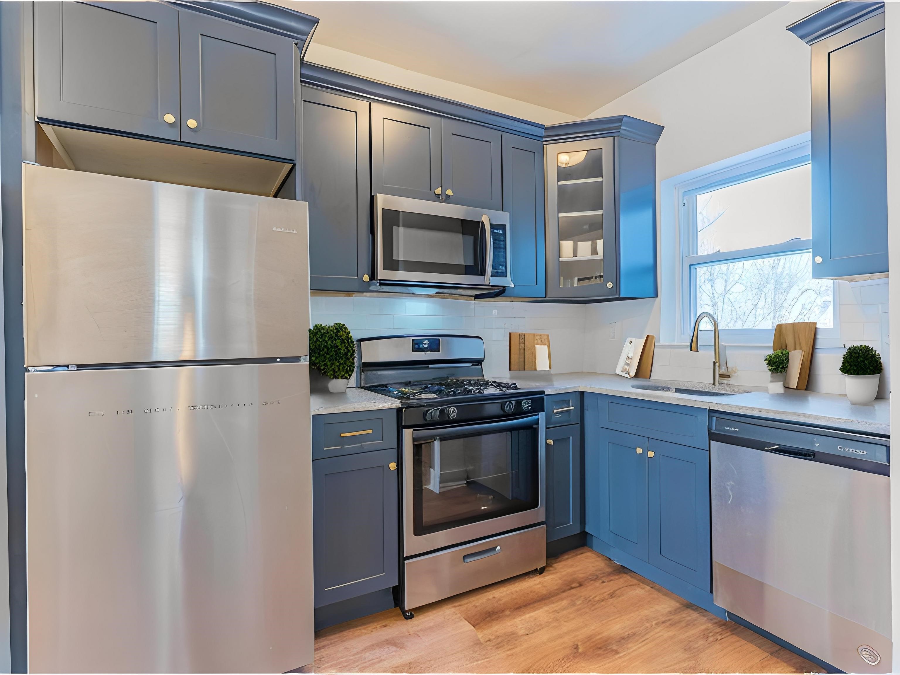 a kitchen with stainless steel appliances granite countertop a refrigerator sink and stove