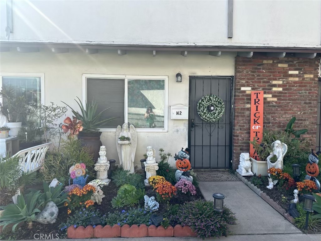 a front view of a house with lots of flowers