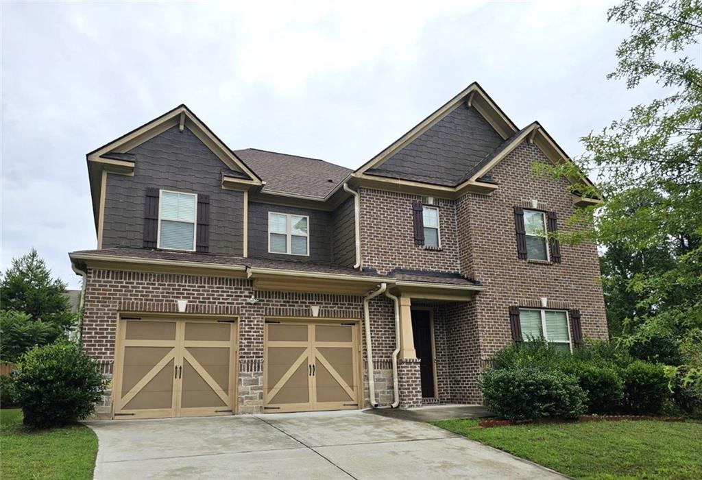 a front view of a house with a yard and garage