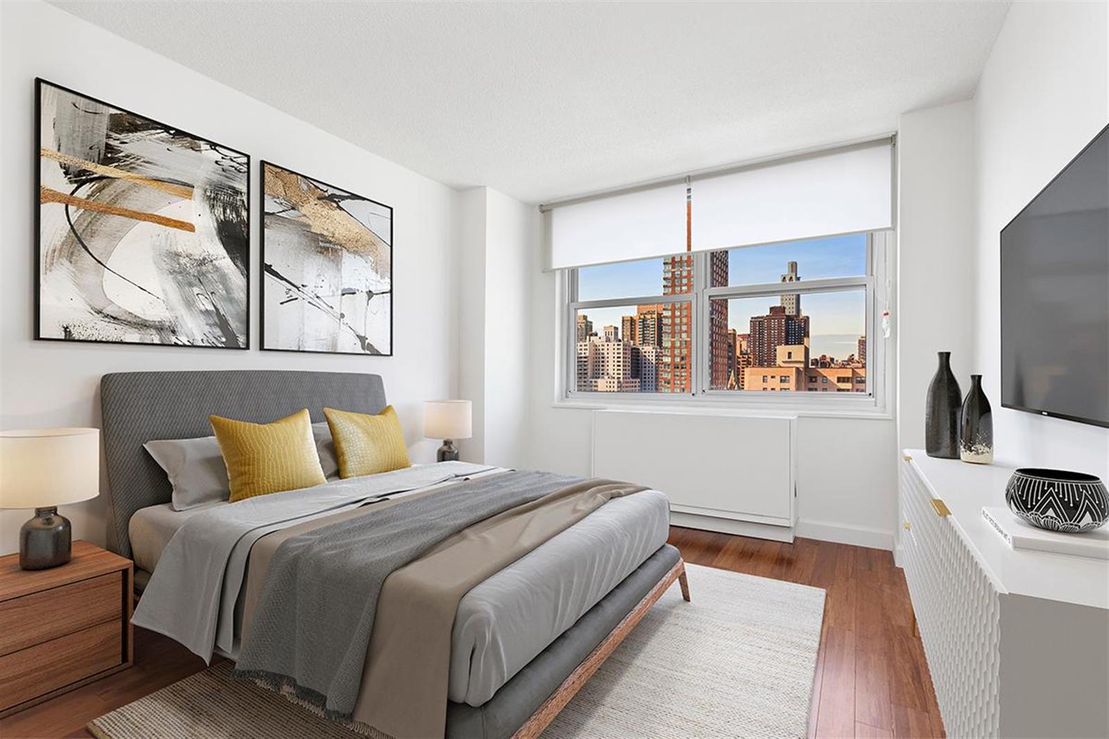 a bedroom with a bed and a painting on the wall