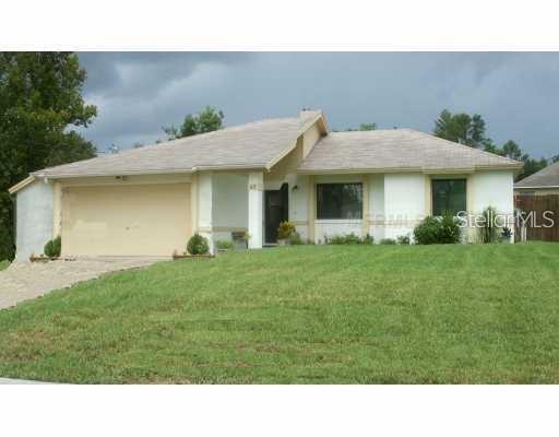 a view of a house with a backyard