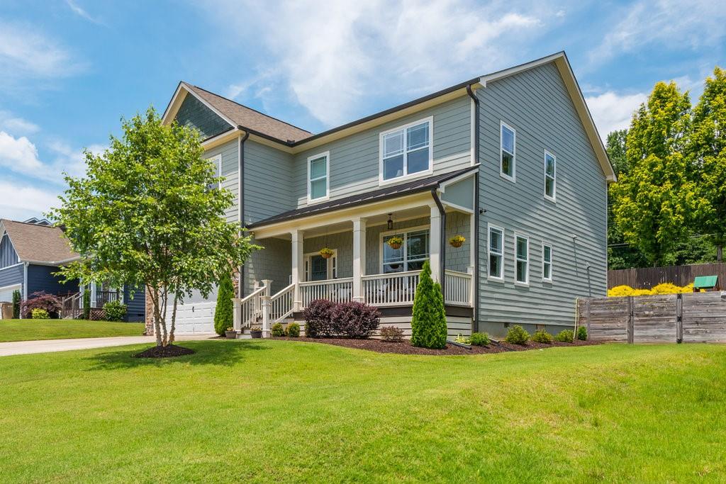 a front view of house with yard and outdoor seating