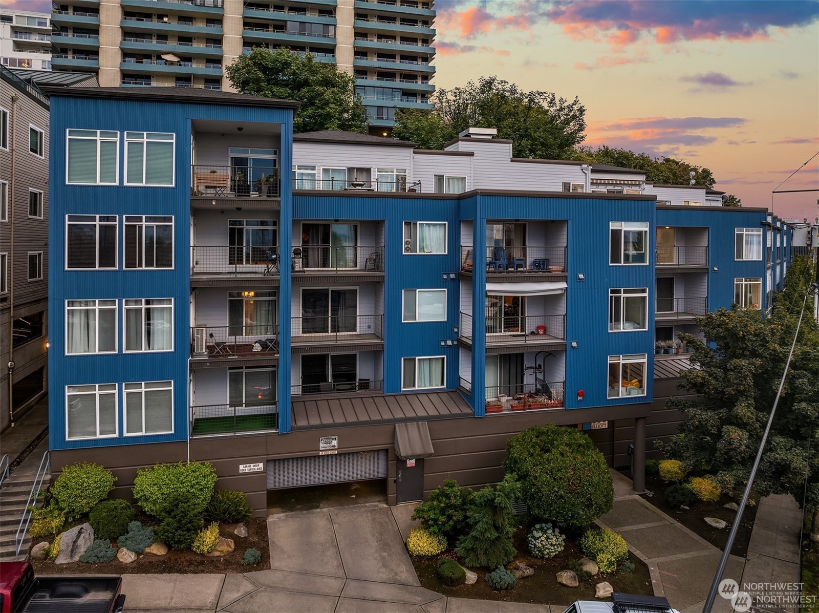 a front view of a residential apartment building with a yard