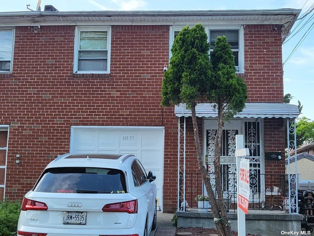 a front view of a house with plants