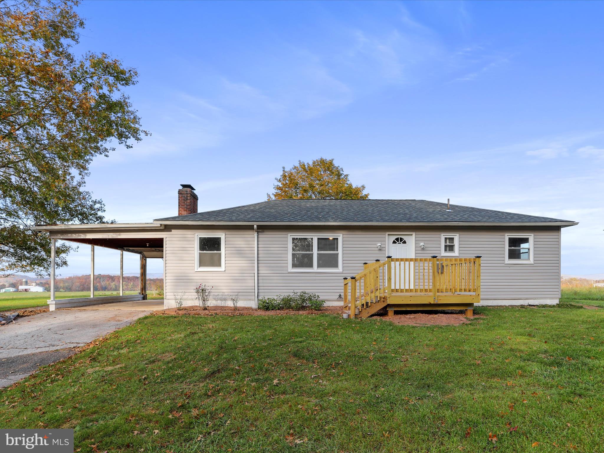 a front view of a house with a yard and trees