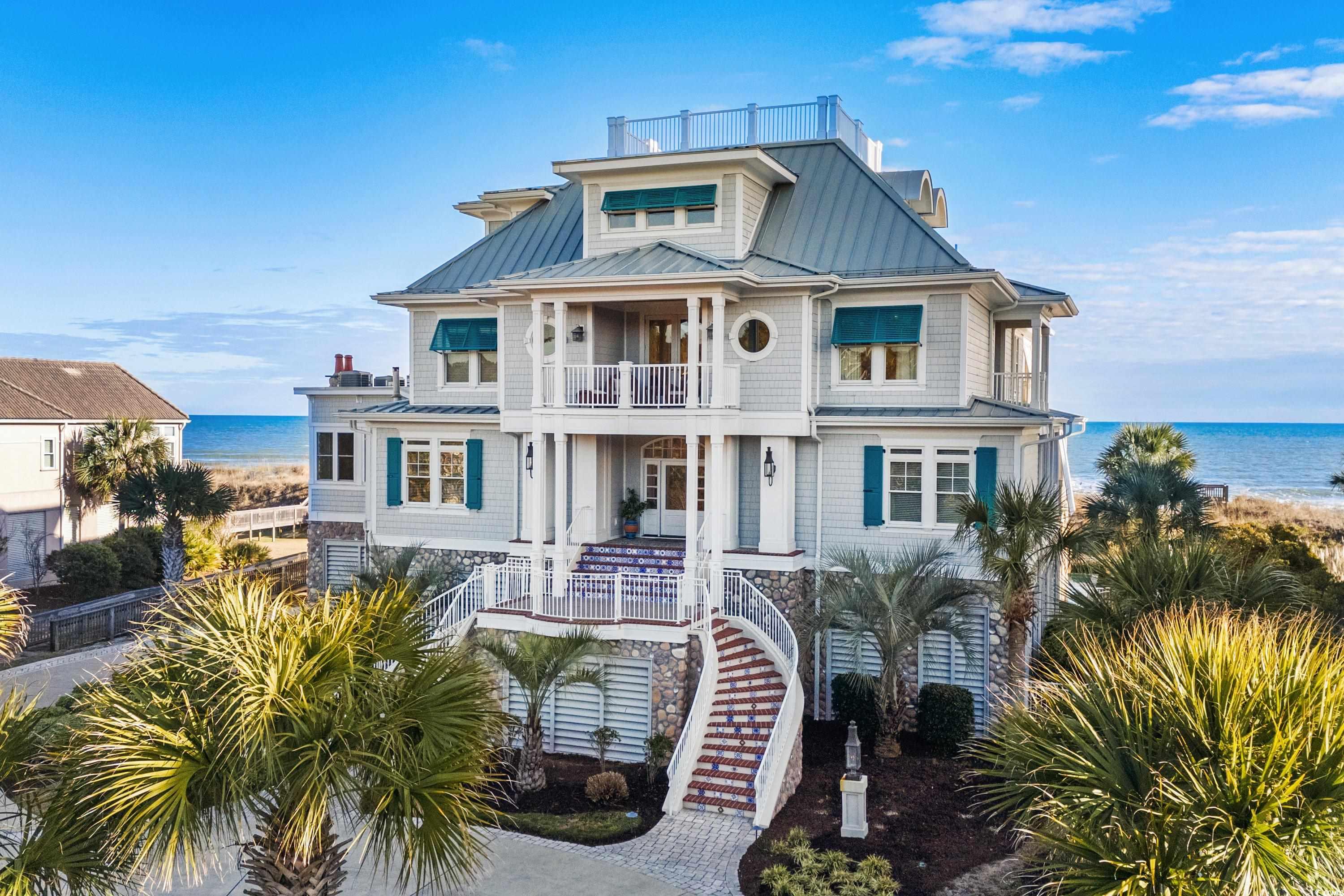 View of front of home featuring a porch, a water v