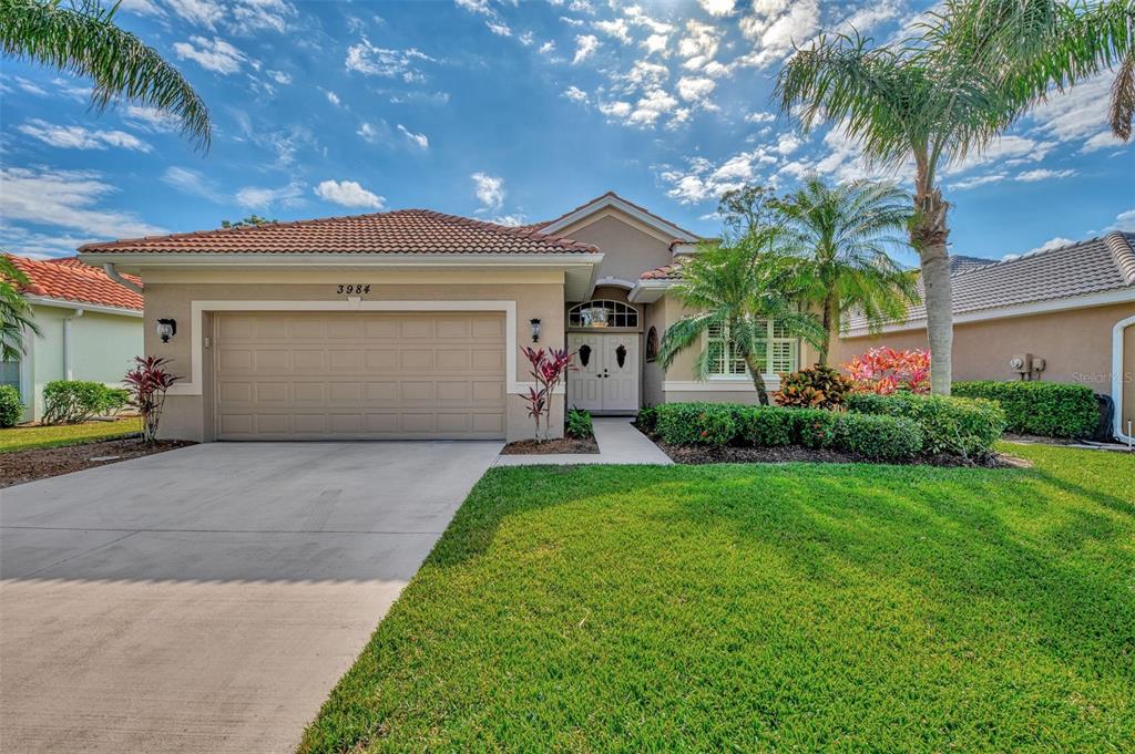 a view of a house with a yard and garage