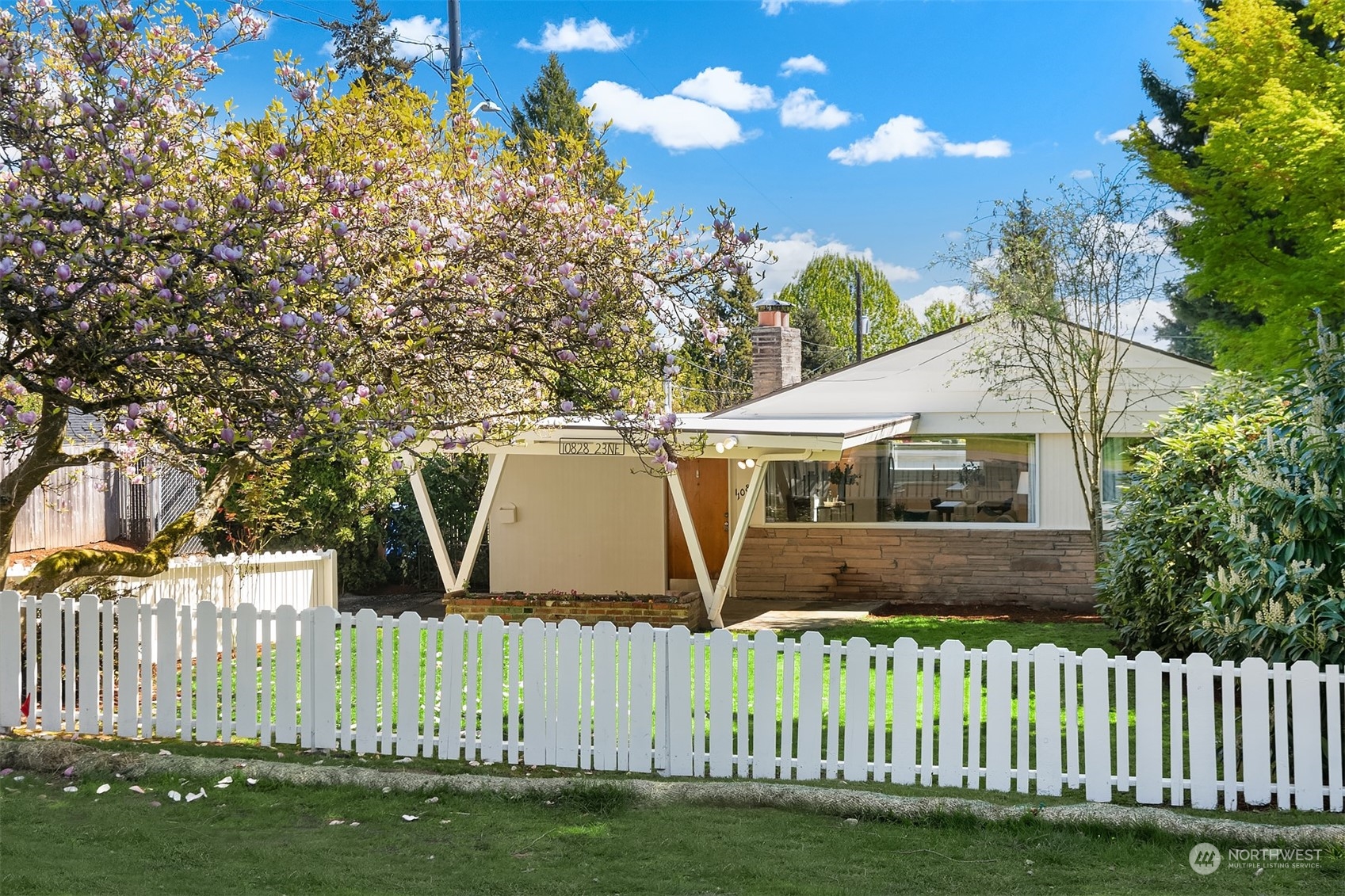 a front view of a house with a garden