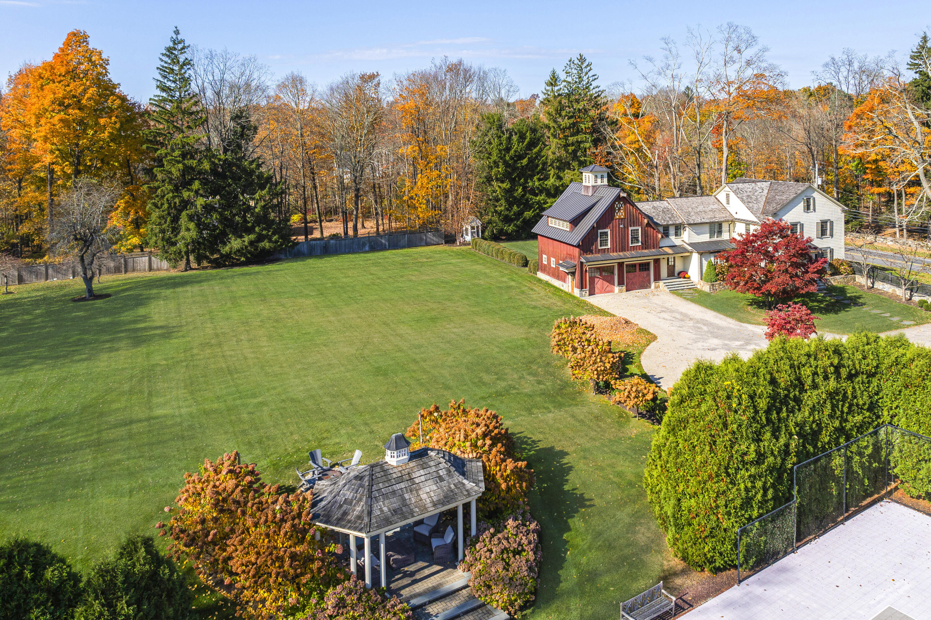 an aerial view of a house with swimming pool garden and lake view