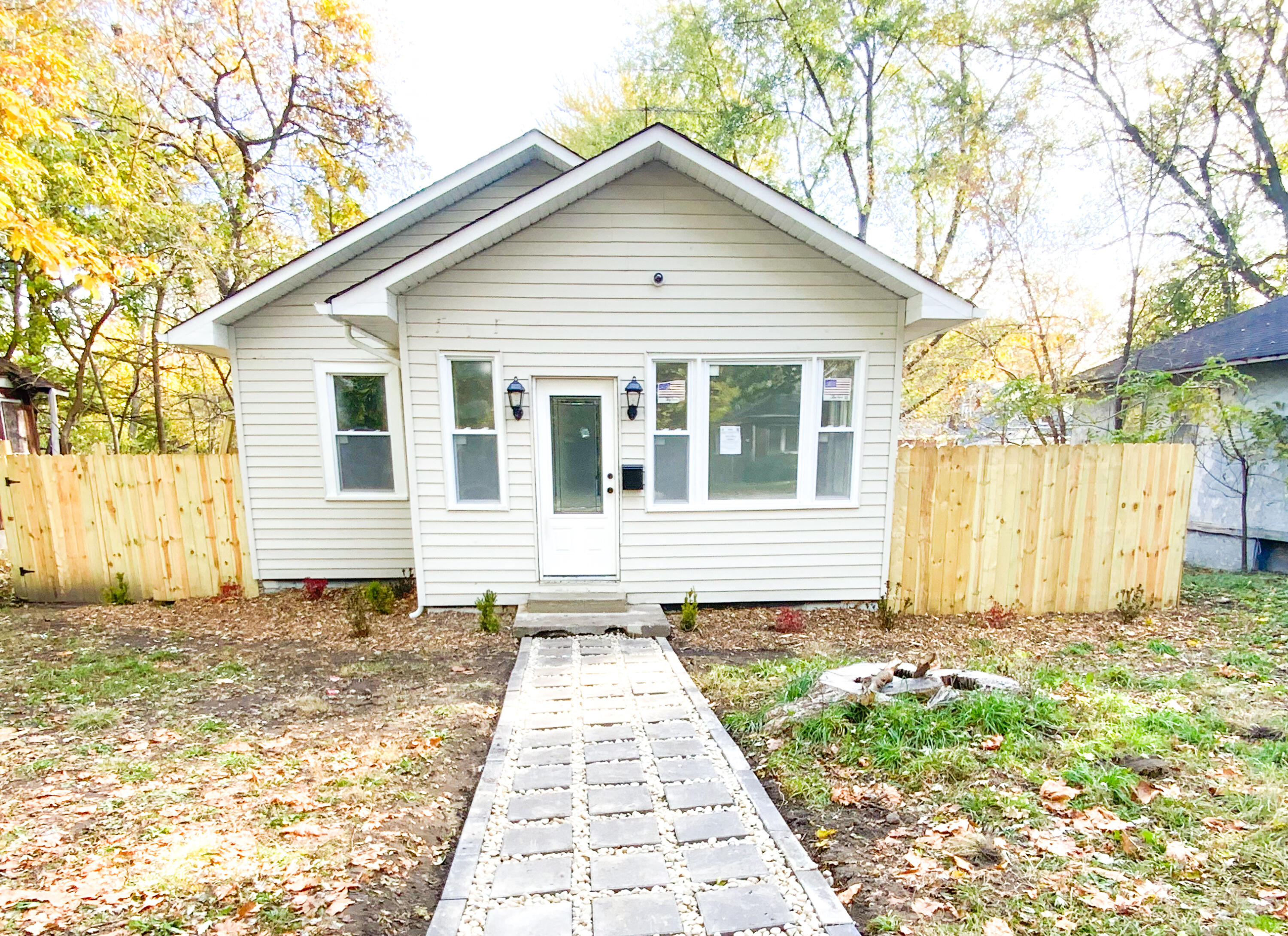 a front view of a house with a garden