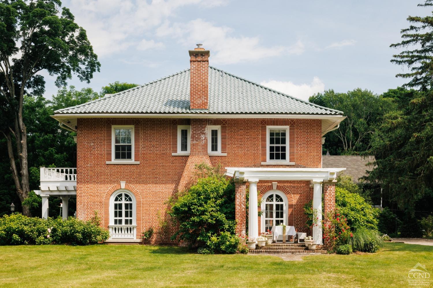 a front view of a house with garden