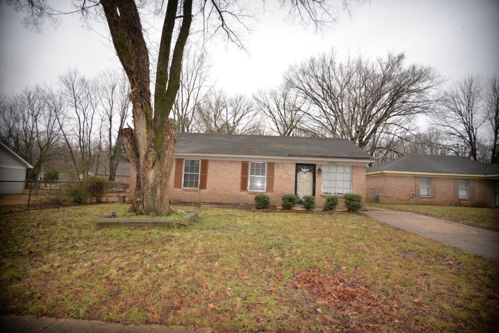 Single story home featuring a front lawn