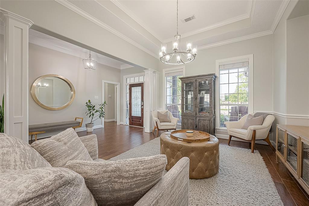 a living room with furniture a chandelier and a fireplace