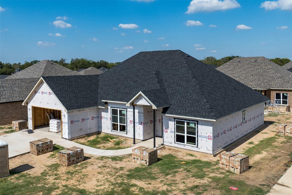 a front view of a house with yard and parking